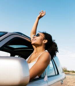 Woman enjoying the breeze out of the passenger side window