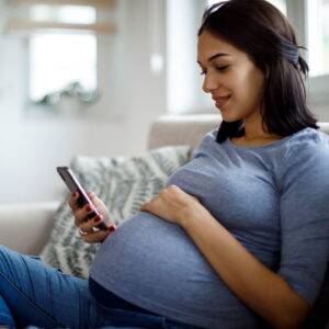 Pregnant woman using phone