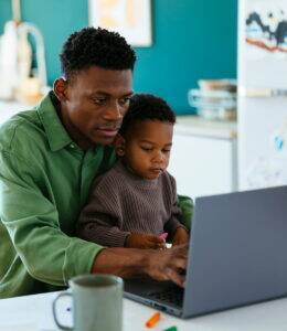 Man and son using laptop